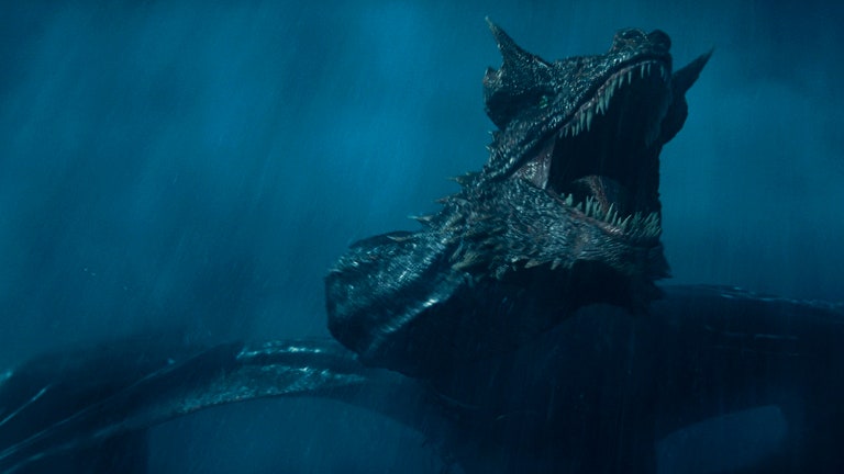 A show still from season 2 of House of the Dragon where a dragon is roaring in a dark sky.