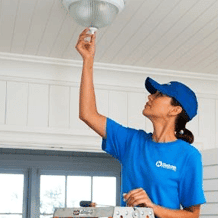 handyperson installing light fixture